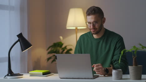 man-is-using-videoconference-at-laptop-communicating-with-partners-or-colleagues-working-remotely-from-home-modern-technology-for-communication